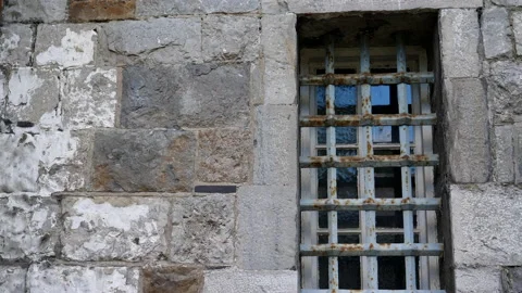 External old jail wall window with bars tilt up Stock Footage 161558125