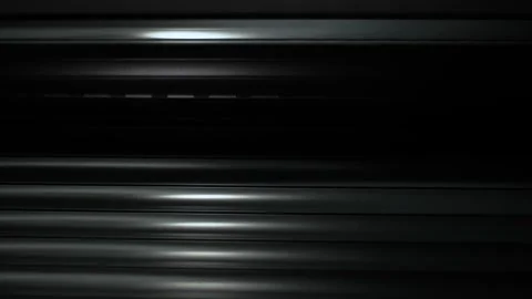 The external roller shutter rolls up, low key background style. Stock Footage 253725169