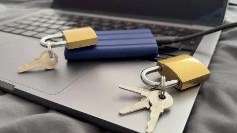 External SSD and Padlocks on Laptop for Secure Data Storage Stock Footage 340407547