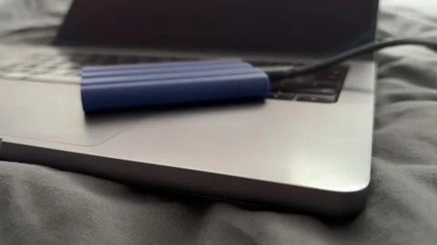 External SSD Connected to Laptop for File Backup and Portable Storage Stock Footage 340407533