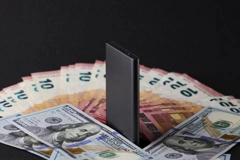 External SSD drive standing over euro and dollar bills representing data ec.. Stock Photos