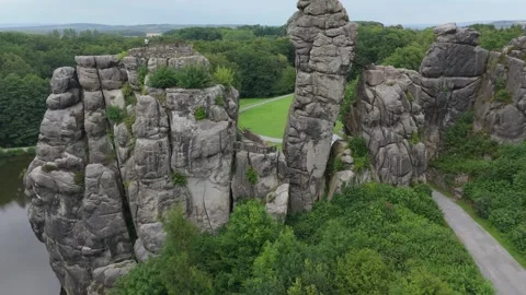 Externsteine Rock Formation With A Distant Town Beyond Stockbeeldmateriaal 339367510