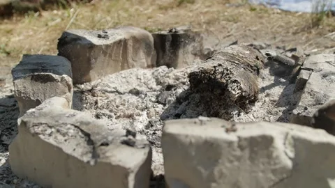 Extinct campfire surrounded by stones during hike at daylight 動画素材 144682972