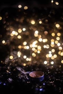 Extinct candle against the backdrop of lights Stock Photos