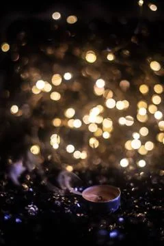 Extinct candle against the backdrop of lights Stock Photos