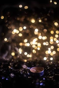 Extinct candle against the backdrop of lights Stock Photos