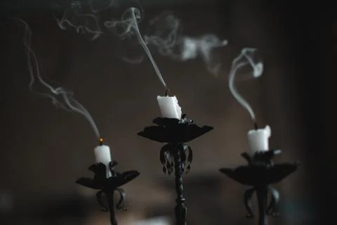 Extinct candle on a candlestick Stock Photos