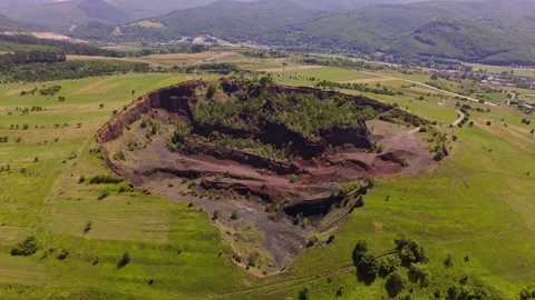 The extinct volcano. Aerial view of volcanic crater covered by green meadow Stock Footage 314040089
