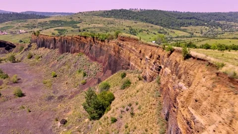 The extinct volcano. Aerial view of volcanic crater covered by green meadow Stock Footage 314040360