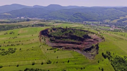 The extinct volcano. Aerial view of volcanic crater covered by green meadow Stock Footage 314040494