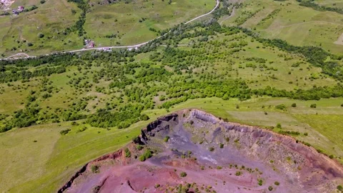 The extinct volcano. Aerial view of volcanic crater covered by green meadow Stock-Footage 314041113