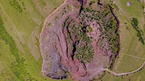 The extinct volcano. Aerial view of volcanic crater covered by green meadow Stock Footage 314043049
