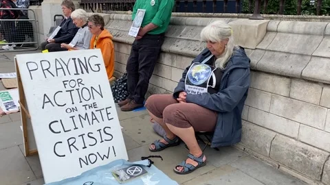 Extinction Rebellion protesters praying for action on the climate crisis. Stock Footage 246501682