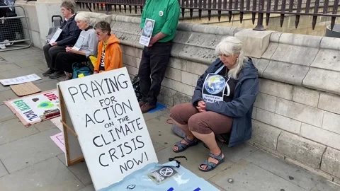Extinction Rebellion protesters praying for action on the climate crisis. Stock Footage 246501684