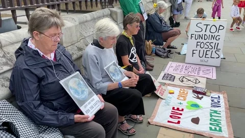 Extinction Rebellion protesters praying for action on the climate crisis. Stock Footage 246501736