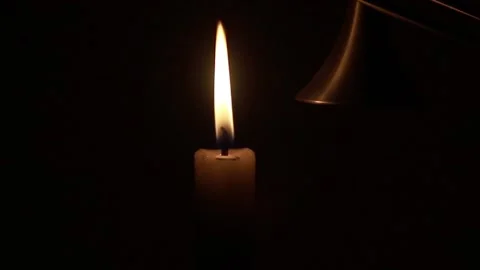 Extinguish a candle with a candle cap Stock Footage 150909785