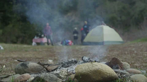 An extinguished campfire smolders while ... | Stock Video | Pond5