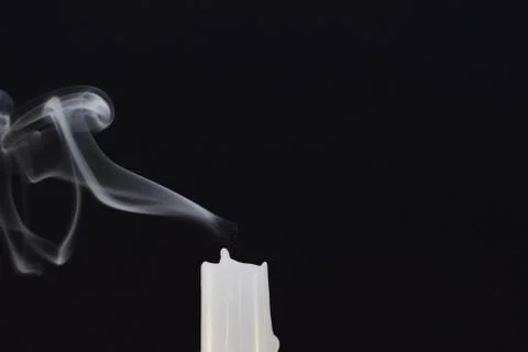 Extinguished the candle on a black background. Stock Photos