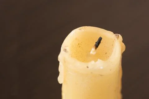 Extinguished candle on dark background with copy space. Stock Photos
