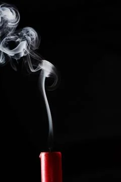 Extinguished candle with smoke trailing off the wick Foto stock