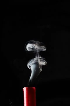 Extinguished candle with smoke trailing off the wick Stock Photos