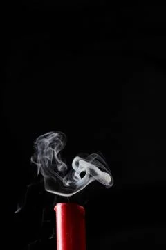 Extinguished candle with smoke trailing off the wick Stock Photos