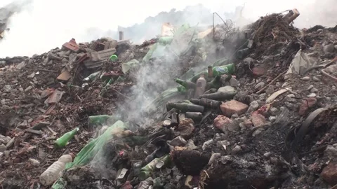 Extinguished fire in the dump, no open flames, smoke rises Stock Footage 130742648
