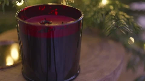 Extinguished red scented candle with smoke trail by Christmas tree, 4K Stock Footage 324595201