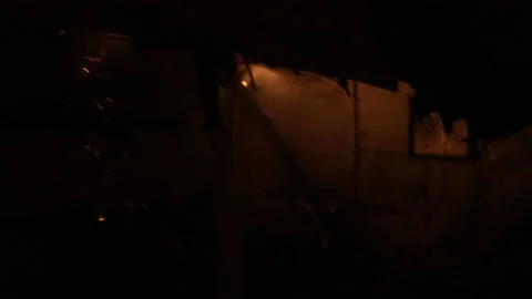Extinguishing a fire at night. The work of firefighters in difficult conditions. Video stock 157909820