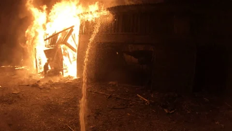 Extinguishing a fire at night. The work of firefighters in difficult conditions. Stock Footage 157909852