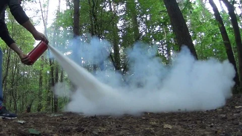 Extinguishing open fire with a powder fire extinguisher. Stock Footage 79992946
