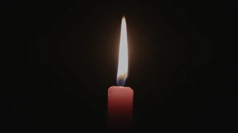 Extinguishing a Red Candle by Hand Stock Footage 39375322