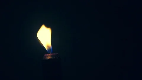 Extinguishing  of a single black burning candle in the darkness Stock Footage 124409780