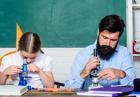 Extra classes. Cognitive skills concept. Schoolgirl likes study with father Stock Photos
