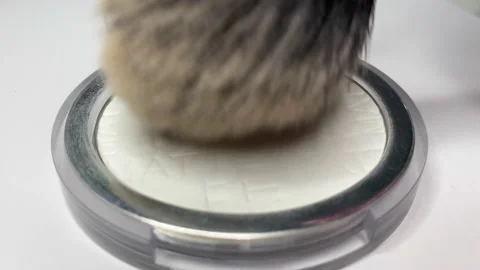 Extra close-up of brush make-up artist with powder on white background. Video Stockbeeldmateriaal 153134807