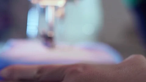 Extra close-up, needle on the sewing machine, she does a seam on clothes. The Stock-Footage 101870177