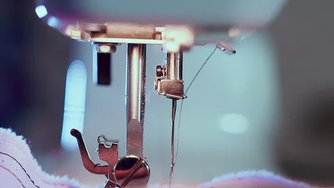 Extra close-up, sewing needle on the machine, the hands of the seamstress cut Stock-Footage 101870211