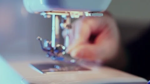 Extra close-up, sewing needle on the machine, the hand of the seamstress inserts Stock-Footage 101870809
