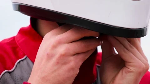 Extra close up view of man is closing helmet fastener. Professional kart driver Stock Footage 136943675