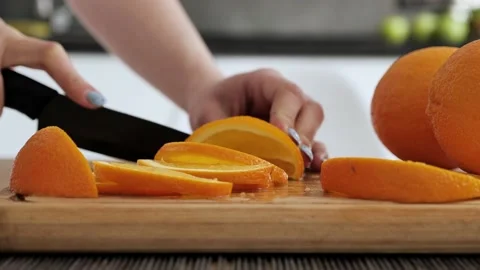 Extra close up woman's hands cut orange. Sliced orange on wood the board. Diet Stock Footage 150804201