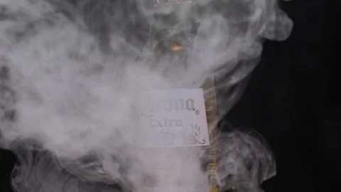 Extra Corona beer bottle spinning with smoke Stock Footage 126225280