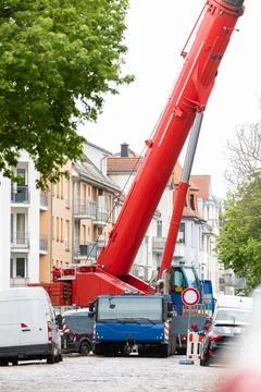 Extra heavy weight load mobile boom crane working on narrow european old city 写真素材
