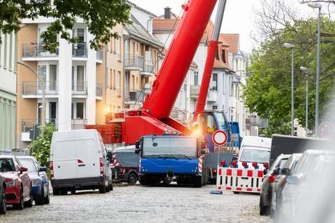 Extra heavy weight load mobile boom crane working on narrow european old city 스톡 사진