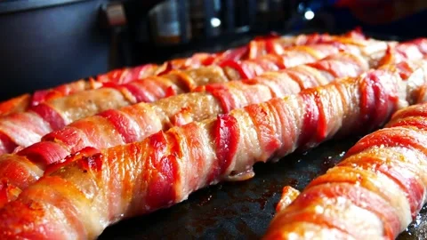 Extra large foot long pigs in blankets traditional bacon wrapped British Stock Footage 167867929