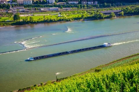 Extra long barge ship is transporting coal on Rhine river near B Stock Photos