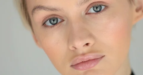 Extra macro portrait female face with skin tone cosmetics close up make up eyes  Stock Footage 90929200