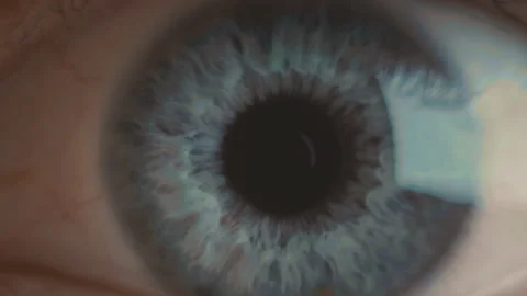 Extra macro shot of deep black pupil, blue iris and eyeball with blood vessels Stock Footage 136473841