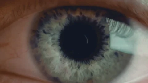 Extra macro shot of man's opening eye with blue iris and big pupil resizing when Stock Footage 136474263