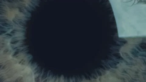 Extra macro shot of man's opening eye with blue iris and big pupil resizing when Stock Footage 136491357