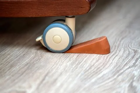 Extra rubber stopper placed under a crib wheel with engaged internal brake .. Stock Photos